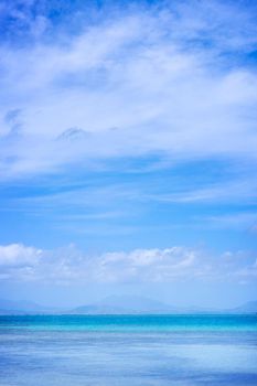 Beautiful ocean scene view isolated with light blue sky background, concept of vacation and sea travel, copy space
