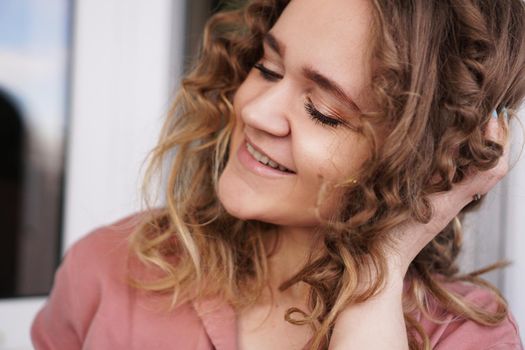 Portrait Of A Pretty Happy Woman with curly hair