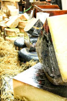 Sale of different kind of cheesses at a market stall in Santa Pola, Spain