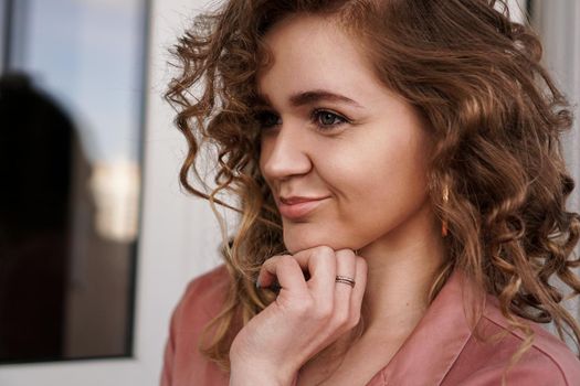 Portrait Of A Pretty Happy Woman with curly hair