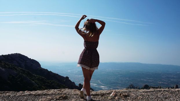 Young happy woman enjoying the magnifisent view of Montserrat Mountains