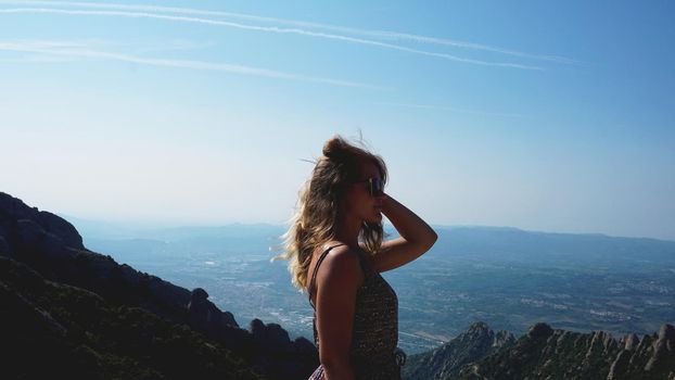 Young happy woman enjoying the magnifisent view of Montserrat Mountains