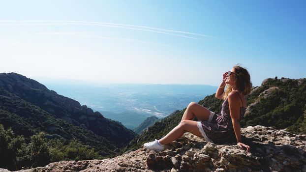 Young happy woman enjoying the magnifisent view of Montserrat Mountains