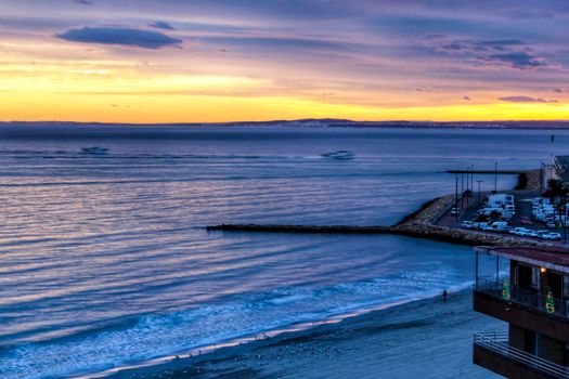 Spectacular and colorful sunset in the bay of Santa Pola, Alicante, Spain in autumn