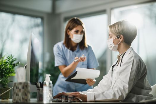 Shot of a female doctor and young nurse working together in consulting room at the hospital.