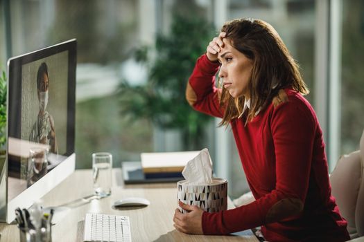 Shot of a young woman having a online consultation with a her doctor on a computer.