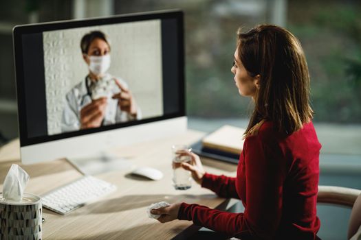 Shot of a young woman having a video call with a her doctor on a computer.