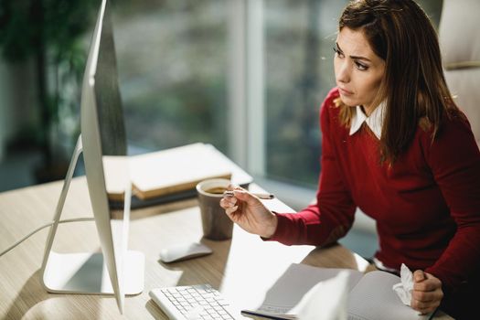 Shot of a young female entrepreneur having online consultations with a her doctor on a computer.