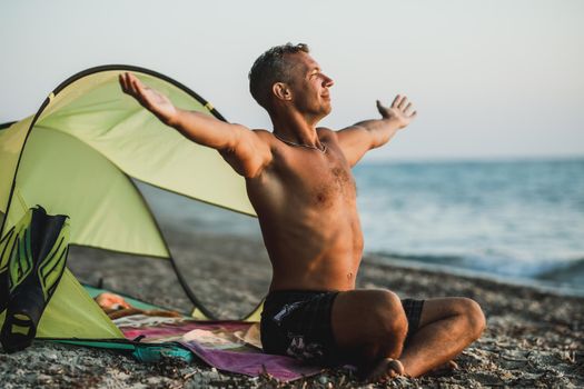 A handsome man enjoying in sunset time on the beach.