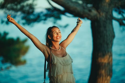 A cheerful young woman having fun on vacation and exploring Mediterranean seaside.