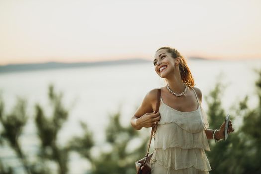 An attractive young woman enjoying a summer vacation while exploring the wonderful seaside of Meditteranian.