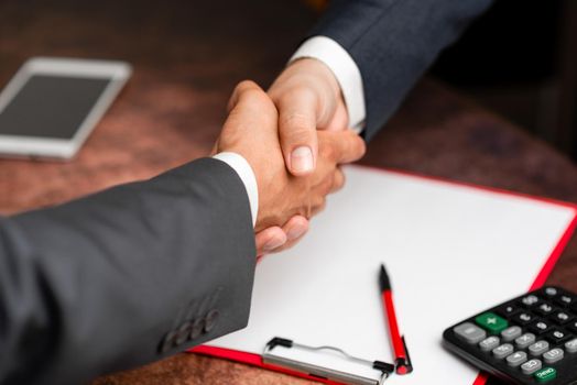 Two Professional Well-Dressed Corporate Businessmen Handshake Indoors