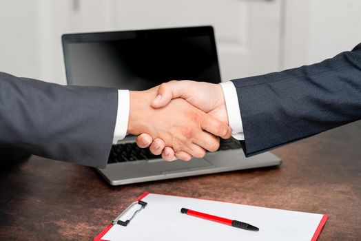 Two Professional Well-Dressed Corporate Businessmen Handshake Indoors