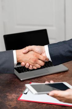 Two Professional Well-Dressed Corporate Businessmen Handshake Indoors