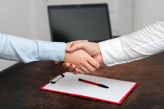 Two Professional Well-Dressed Corporate Businessmen Handshake Indoors