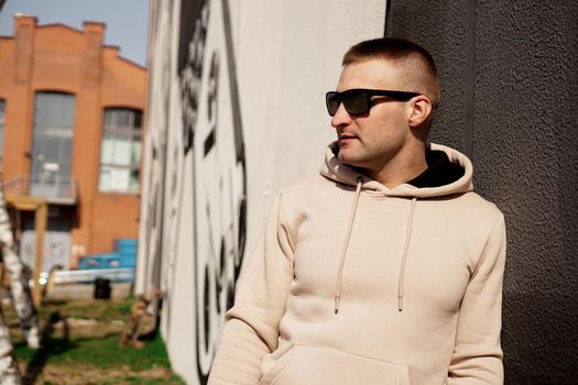 Hipster man in the street in summer day. Young man in sunglasses. Lifestyle photo