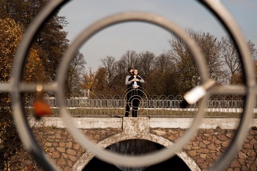 Romantic couple in the autumn park - sunny day - love, relationship and dating concept