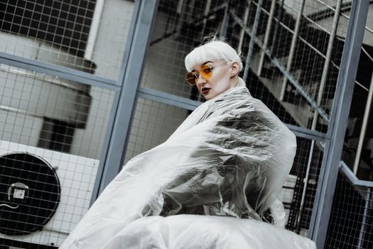 Ecology concept. Girl with plastic wrap. City Style. Urban photo