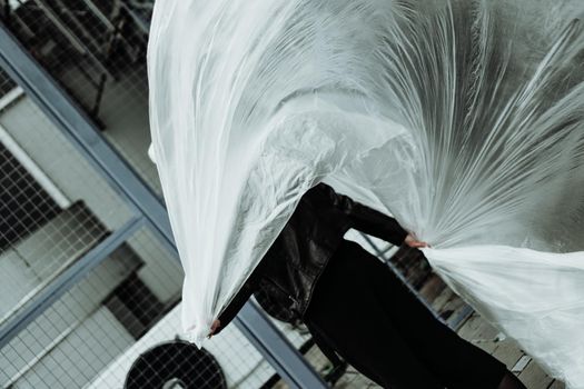 Ecology concept. Girl with plastic wrap. City Style. Urban photo