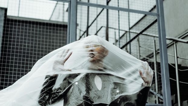 Ecology concept. Girl with plastic wrap. City Style. Urban photo