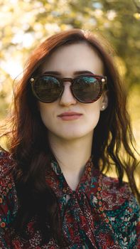 Smiling summer woman with sunglasses. Beautiful Young Woman Outdoor. Enjoy Nature. Healthy Smiling Girl in the Spring Park. Sunny day