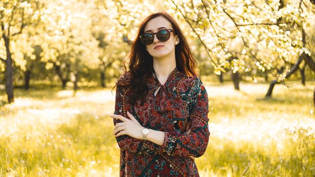 Smiling summer woman with sunglasses. Beautiful Young Woman Outdoor. Enjoy Nature. Healthy Smiling Girl in the Spring Park. Sunny day