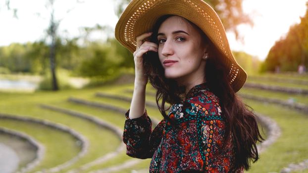 Beautiful young lady in shine through dress touch straw hat. Girl walk at hillside like rice farming