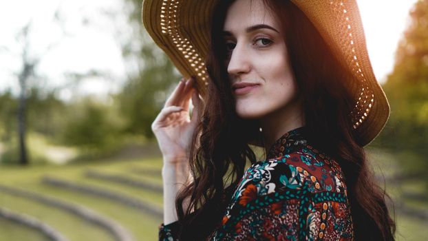 Beautiful young lady in shine through dress touch straw hat. Girl walk at hillside like rice farming