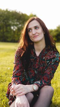 Attractive young woman enjoying her time outside in park - summer time