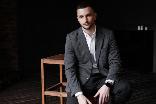 Portrait of a young attractive handsome elegant man on dark background