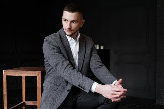 Portrait of a young attractive handsome elegant man on dark background