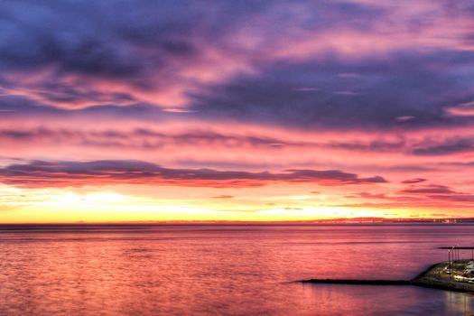 Spectacular and colorful sunset in the bay of Santa Pola, Alicante, Spain in autumn