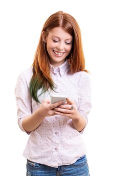 Beautiful young woman looking at her mobile phone, smiling and reading messages or surfing the internet or shopping online or texting, isolated on white background. Technology and social media concept.