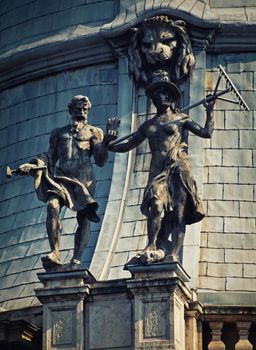 Close up of allegorical statues on the baroque wing dome of Vajdahunyad Castle, currently the agricultural museum in Budapest, Hungary. Art and architecture concept.