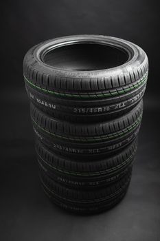 stack of summer tires, gray background