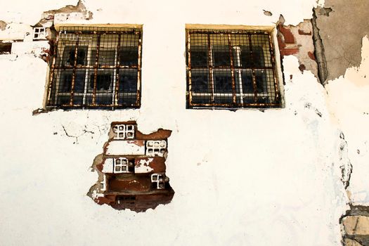 Old and damaged wall texture with windows