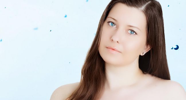 Rejuvenation skincare and beauty ad, beauty face portrait of young woman with healthy clean skin, blue cosmetic liquid drops on background.