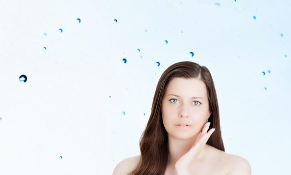 Rejuvenation skincare and beauty ad, beauty face portrait of young woman with healthy clean skin, blue cosmetic liquid drops on background.