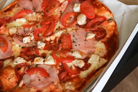 Pizza with chicken, cheese and ham close up, food