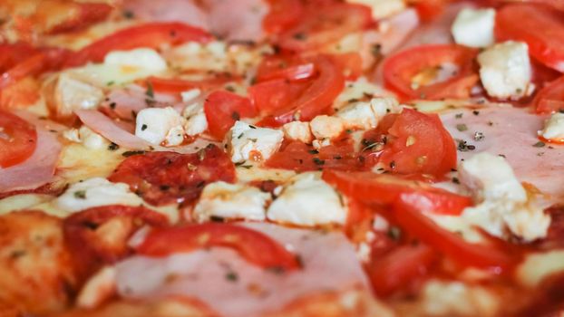 Pizza with chicken, cheese and ham close up, background or texture