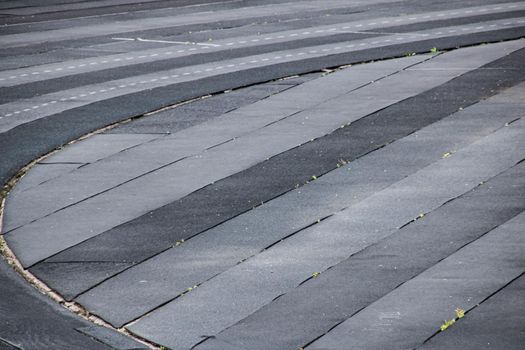 Gray running track in the stadium close up, background