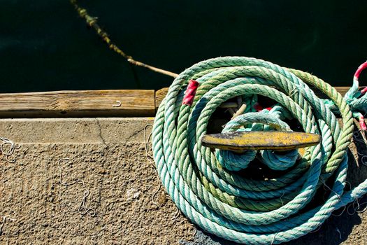 Blue Coiled rope in the dock in the morning