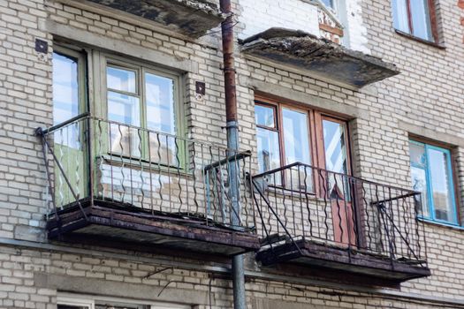 Balconies and windows on an old abandoned building close up