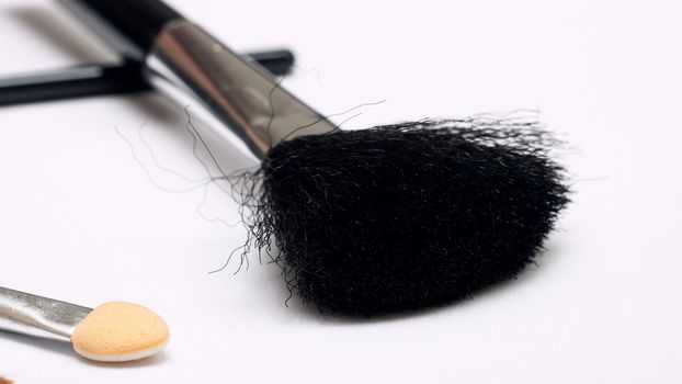 Brush for applying blush, makeup accessories on a white background