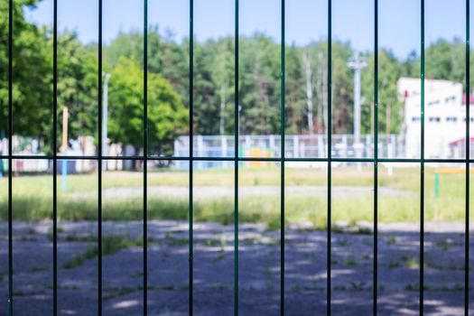 Stadium behind a blue mesh fence close up, background or texture