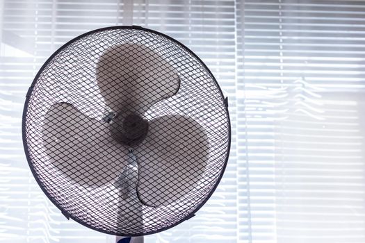 White fan on the background of the window close up, copy space
