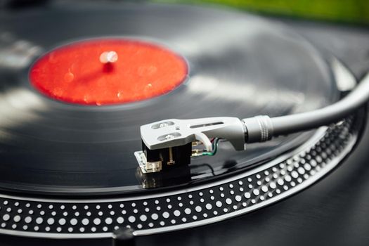 turntable with LP vinyl record, closeup view