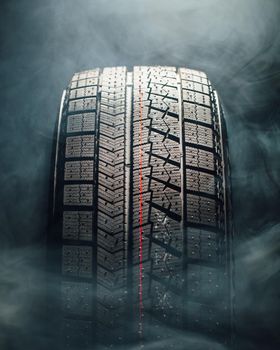 winter tire in smoke, closeup view