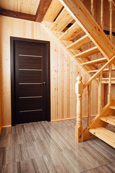 staircase and door inside of wooden house