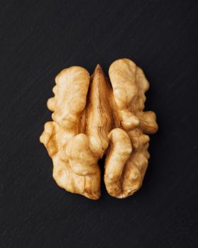 shelled walnut on black background